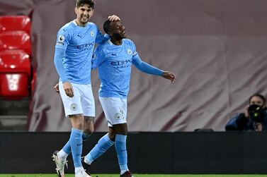 Manchester City's Raheem Sterling (R) celebrates with John Stones after scoring the third goal against Liverpool. EPA