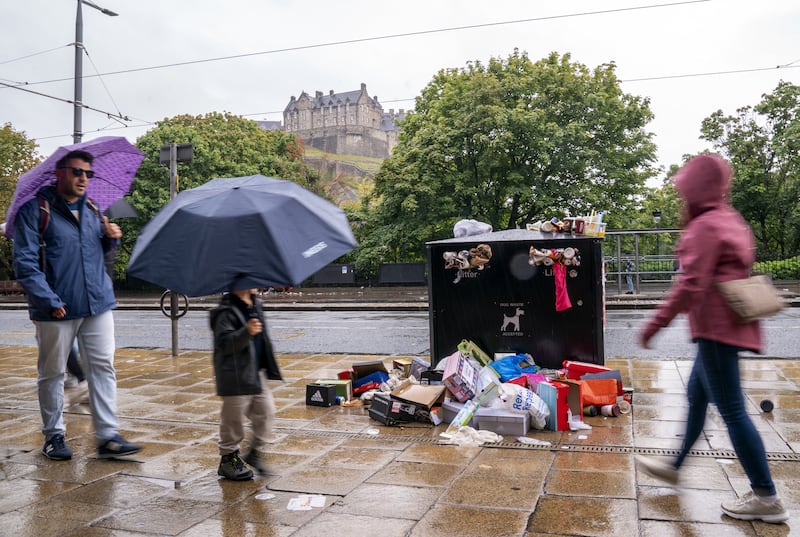 Bins overflow with rubbish along Princes Street in Edinburgh on Monday, as a strike by municipality cleaners entered its fourth day. PA