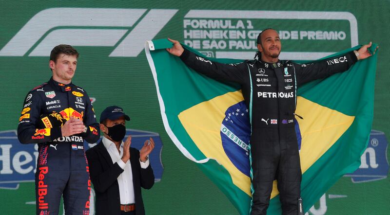 Hamilton celebrates on the podium after winning the Brazilian Grand Prix - alongside second-placed Red Bull driver Max Verstappen - at Jose Carlos Pace Circuit, Sao Paulo on November 14, 2021. Reuters