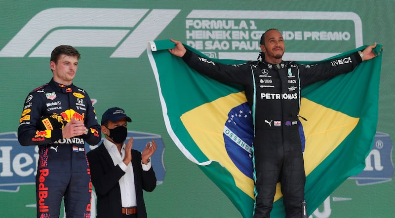 Hamilton celebrates on the podium after winning the Brazilian Grand Prix - alongside second-placed Red Bull driver Max Verstappen - at Jose Carlos Pace Circuit, Sao Paulo on November 14, 2021. Reuters