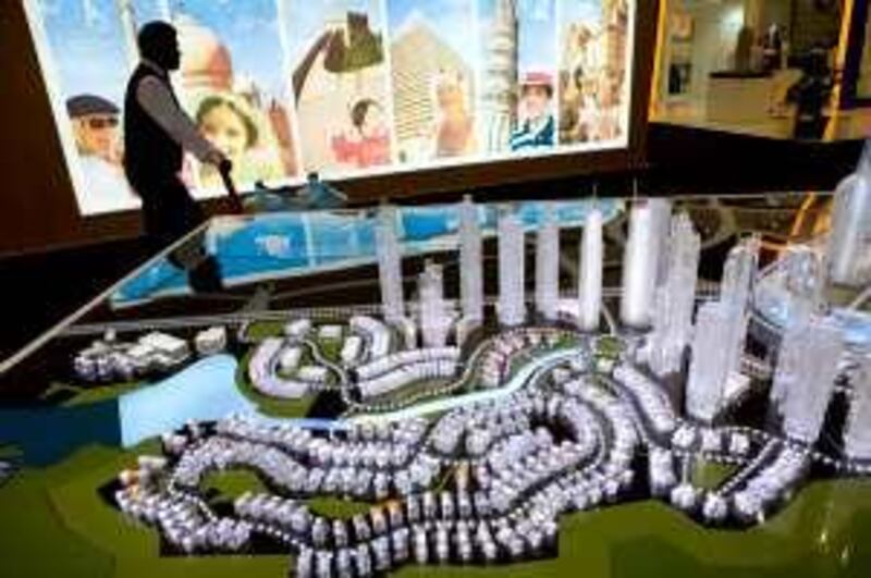 United Arab Emirates - Abu Dhabi - April 22 - 2009 :  A worker walks beside a scale model of Medini Central project at Iskandar showroom during Cityscape Abu Dhabi in Abu Dhabi National Exhibition Centre. ( Jaime Puebla / The National ) *** Local Caption ***  JP29 CITYSCAPE AD.jpg