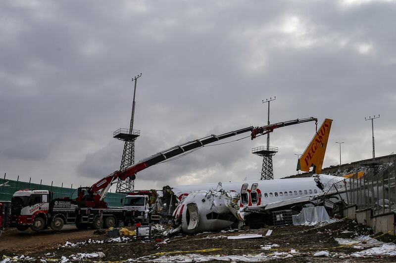 Workers remove the wreckage after investigators has finished their work at the Pegasus Airlines plane that skidded Wednesday off the runway at Istanbul's Sabiha Gokcen Airport, in Istanbul. AP Phot