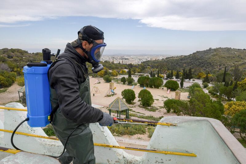 A health worker disinfects the Enahli amusement park at Ariana near Tunis.  AFP