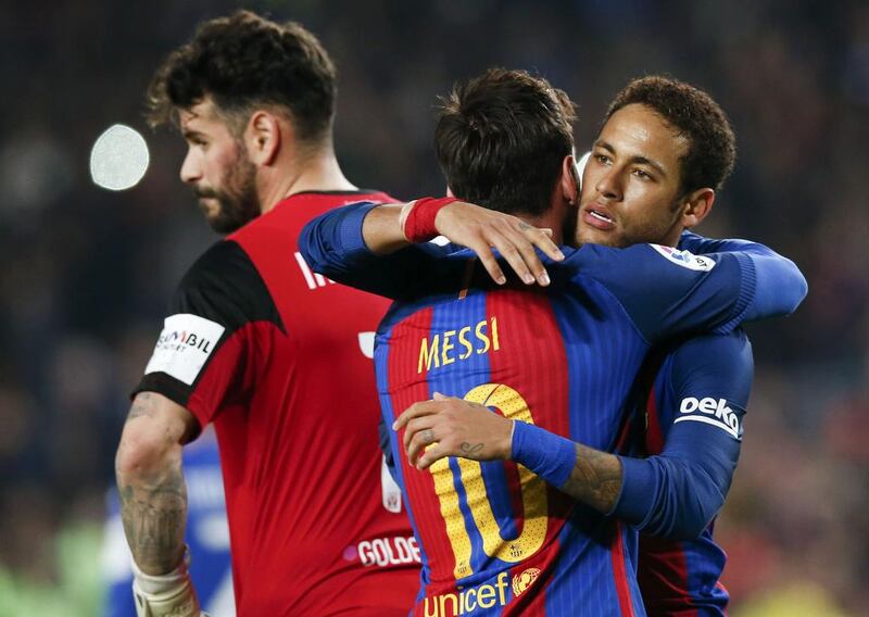 Barcelona’s Lionel Messi celebrates with teammate Neymar after scoring a penalty against Leganes. Albert Gea / Reuters