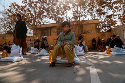 Internally displaced persons receive food aid distributed by German government in Kabul, on December 2. EPA 