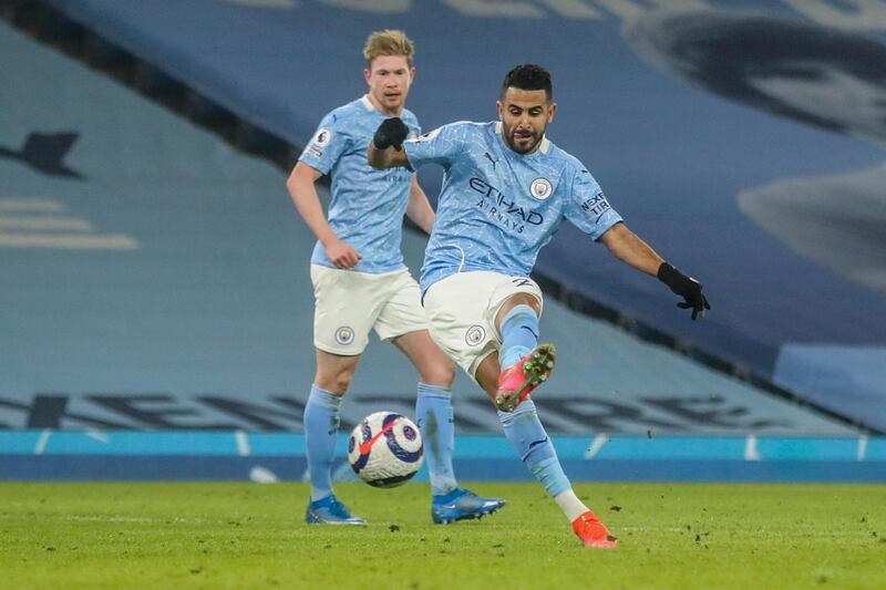 Manchester City's Riyad Mahrez scores his team third goal during the English Premier League soccer match between Manchester City and Wolves at the Etihad stadium in Manchester, England, Tuesday, March 2, 2021. (Carl Recine/Pool via AP)