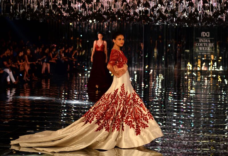 The designer is known for his ‘the bigger the better’ aesthetic, as evidenced in the long trails of the women's lehengas. AFP