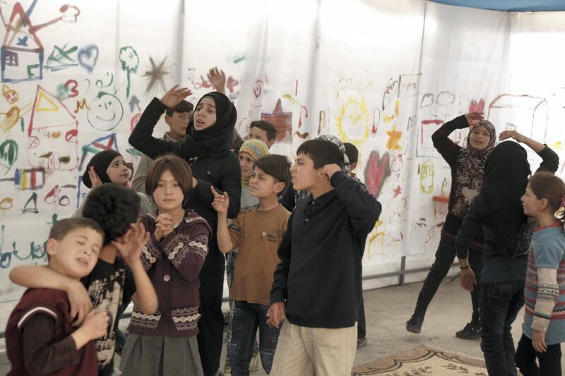 The children and their mentor gather regularly throughout the week in a makeshift tent in Al Bab. Bader Taleb