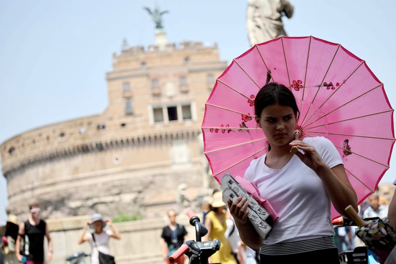An umbrella provides shade during a heatwave in Rome. The Italian Health Ministry has put out a red alert. EPA