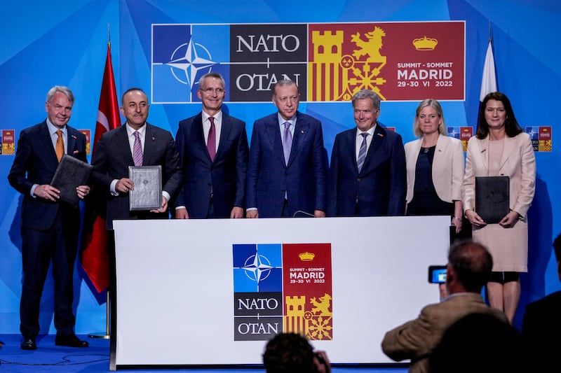 From left to right background: Finnish Foreign Minister Pekka Haavisto, Turkish Foreign Minister Mevlut Cavusoglu, NATO Secretary General Jens Stoltenberg, Turkish President Recep Tayyip Erdogan, Finland's President Sauli Niinisto, Sweden's Prime Minister Magdalena Andersson, and Sweden's Foreign Minister Ann Linde pose for a picture after signing a memorandum in which Turkey agrees to Finland and Sweden's membership of the defense alliance in Madrid, Spain on Tuesday, June 28, 2022.  North Atlantic Treaty Organization heads of state will meet for a summit in Madrid from Tuesday through Thursday.  (AP Photo / Bernat Armangue)
