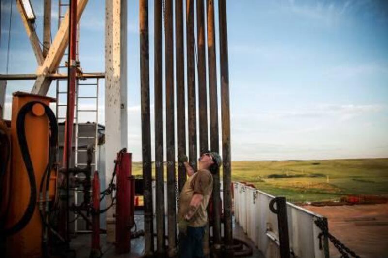 WATFORD CITY, ND - JULY 23: Glen Crabtree, a floor hand for Raven Drilling, waits to line up pipe while drilling for oil in the Bakken shale formation on July 23, 2013 outside Watford City, North Dakota. North Dakota is been experiencing an oil boom in recent years, due in part to new drilling techniques including hydraulic fracturing and horizontal drilling. In April 2013, The United States Geological Survey released a new study estimating the Bakken formation and surrounding oil fields could yield up to 7.4 billion barrels of oil, doubling their estimate of 2008, which was estimated at 3.65 billion barrels of oil.   Andrew Burton/Getty Images/AFP