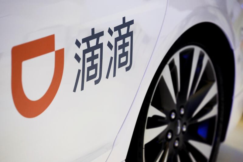 FILE PHOTO: The company logo of ride hailing company Didi Chuxing is seen on a car door at the IEEV New Energy Vehicles Exhibition in Beijing, China October 18, 2018.  REUTERS/Thomas Peter/File Photo