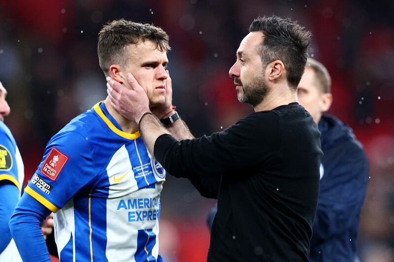 Solly March is consoled by Brighton manager Roberto De Zerbi after his penalty miss. Getty 