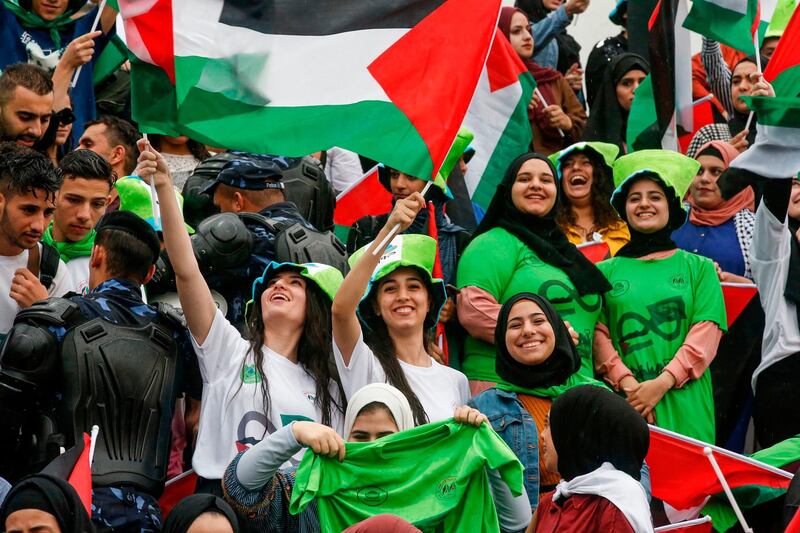 Women football fans wave Palestinian flags as they attend the World Cup 2022 Asian qualifying match between Palestine and Saudi Arabia in the town of al-Ram in the Israeli occupied West Bank. The game would mark a change in policy for Saudi Arabia, which has previously played matches against Palestine in third countries. Arab clubs and national teams have historically refused to play in the West Bank, where the Palestinian national team plays, as it required them to apply for Israeli entry permits. AFP