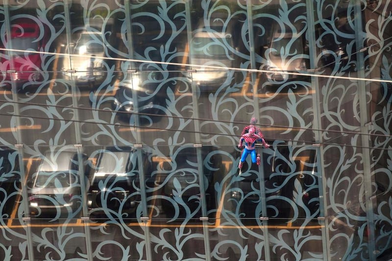 A Spider-Man model hangs from a glass facade of a spa building in Guangzhou, Guangdong province. As a fan of the Spider-Man comic book series, the owner had the figure attached to the building in hope of boosting his spa business. Alex Lee / Reuters