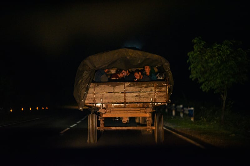 Ethnic Armenians from Nagorno-Karabakh sit in the back of a vehicle after crossing the border on their way to an Armenian Ministry of Foreign Affairs registration centre in Kornidzor, Armenia. EPA