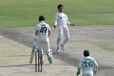 Pakistan's Naseem Shah (C) celebrates after taking the wicket of Australia's Steve Smith (L) during the first day of the third and final Test cricket match between Pakistan and Australia at the Gaddafi Cricket Stadium in Lahore on March 21, 2022.  (Photo by Arif ALI  /  AFP)