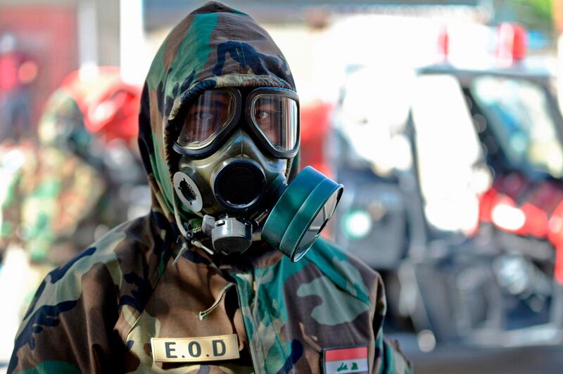 A member of the Iraqi civil defence prepares to disinfect a neighbourhood in Najaf.  AFP