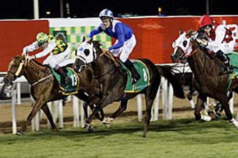Richard Hills, in the blue, is in action in Jebel Ali this afternoon on Aamaaq.