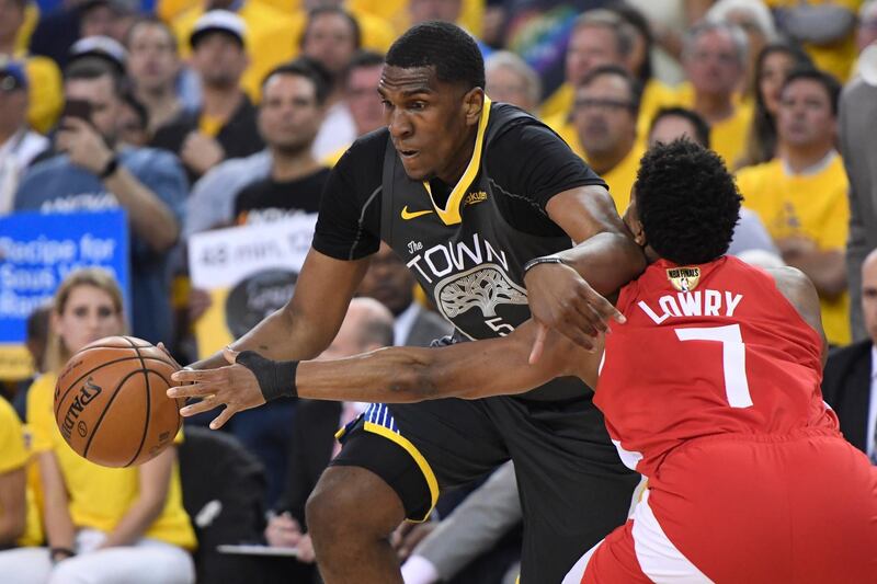 Toronto Raptors guard Kyle Lowry (7) reaches for the ball controlled by Golden State Warriors center Kevon Looney. AP Photo