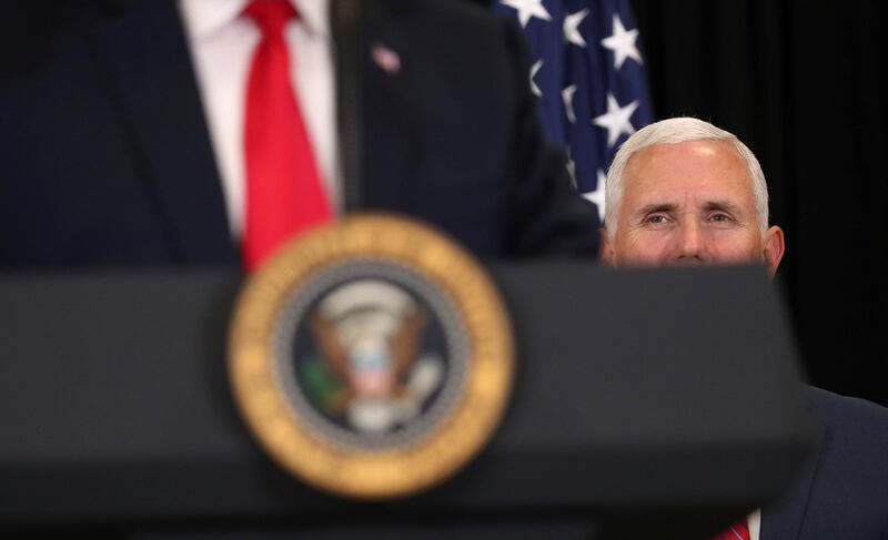 U.S. President Donald Trump is watched by Vice President Mike Pence as they take part in the swearing-in ceremony for the Central Intelligence Agency's first female director, Gina Haspel, at CIA Headquarters in Langley, Virginia, U.S., May 21, 2018. REUTERS/Kevin Lamarque