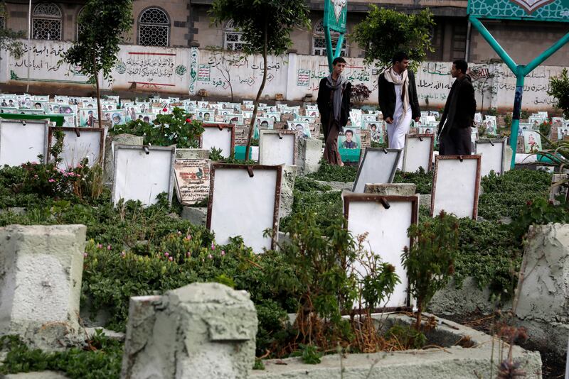 Yemenis visit the graves of people killed in the country's civil war, at a cemetery in Sanaa. EPA