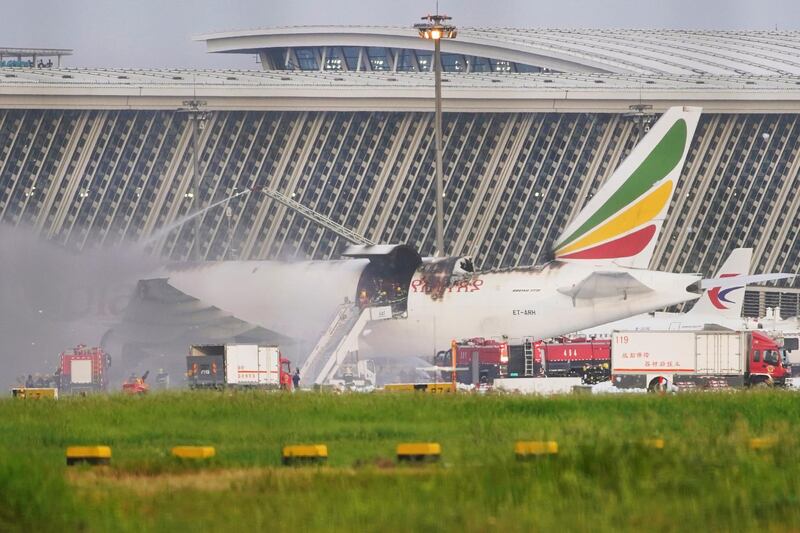 Firefighters work at the site where an Ethiopian Airlines cargo plane caught fire, at Shanghai Pudong International Airport in Shanghai, China July 22, 2020.  REUTERS/Aly Song