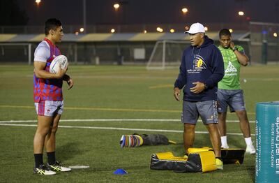 DUBAI , UNITED ARAB EMIRATES – Jan 10 , 2017 : Noah Perelini ( left ) during the Rugby training session with his father Apollo Perelini ( 2nd right ) at the Rapton school in Dubai. ( Pawan Singh / The National ) For Sports. Story by Paul Radley. ID No - 98771 *** Local Caption ***  PS1001- RUGBY08.jpg