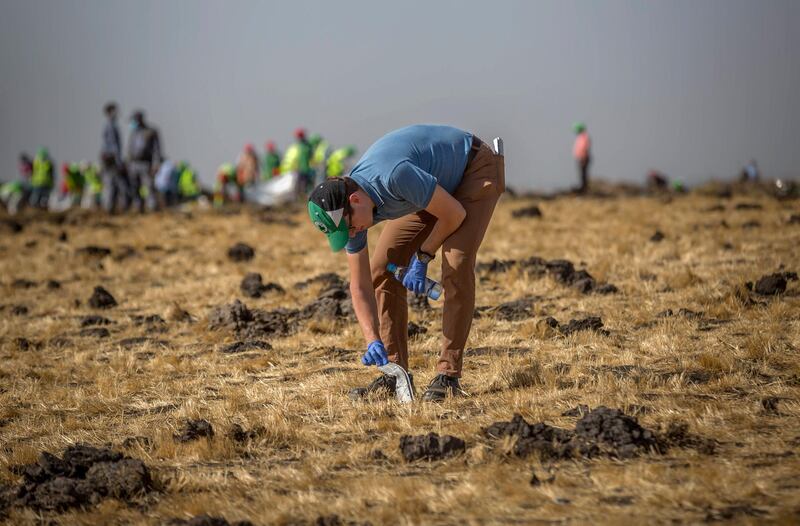 A foreign investigator examines wreckage. AP Photo