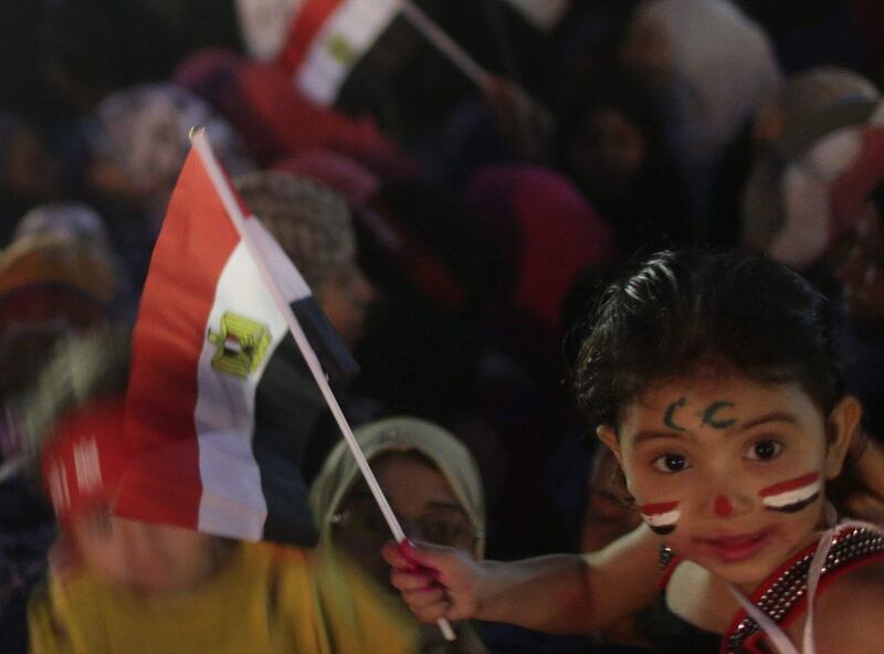 A child waves an Egyptian flag on the third day of voting in Egypt's presidential election. Asmaa Waguih / Egypt