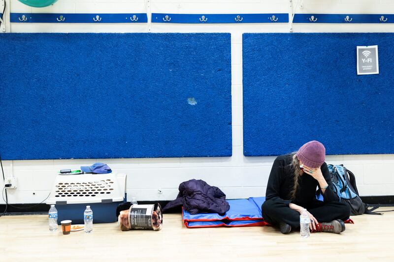 A woman sits in the YMCA Northern Colorado after leaving her home. Reuters