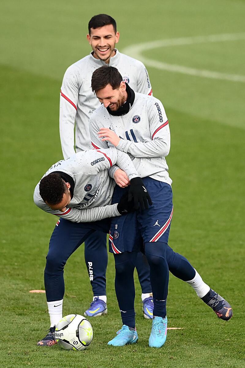 Neymar and Lionel Messi fool around at training watched by Leandro Paredes. AFP