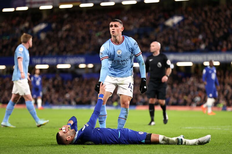 Phil Foden of Manchester City helps Hakim Ziyech of Chelsea back to his feet. Getty 