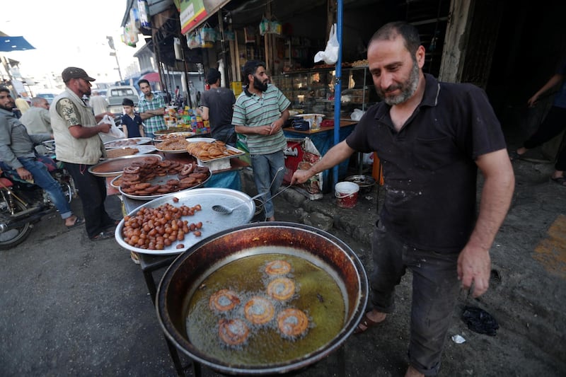 A vendor prepares traditional sweets for sale before the time for iftar, or breaking fast, during the Muslim fasting month of Ramadan in the city of Idlib, Syria. REUTERS