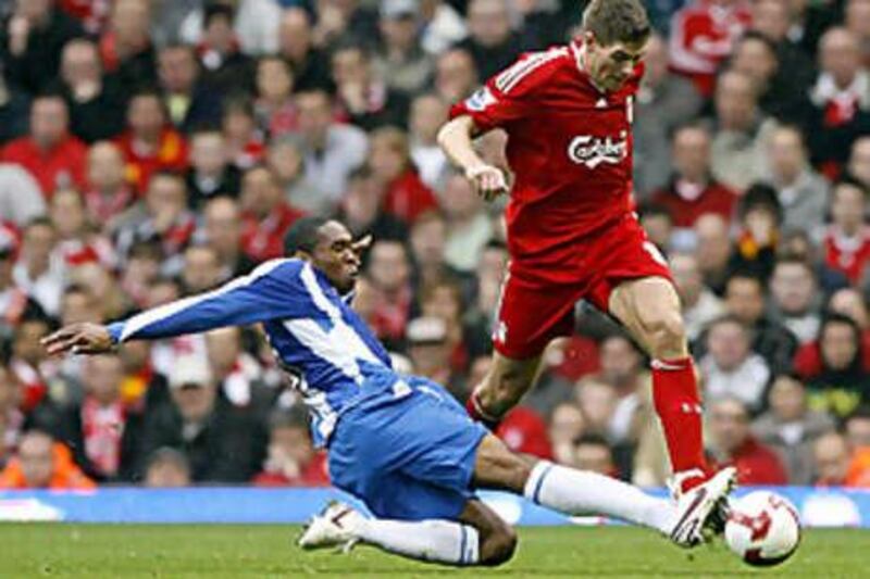 Wigan Athletic's Wilson Palacios, left, and Liverpool's Steven Gerrard battle for the ball during the English Premier League soccer match at Anfield, Liverpool, England, Saturday Oct. 18, 2008. Liverpool won the match 3-2. (AP Photo/PA, Peter Byrne) ** UNITED KINGDOM OUT NO SALES NO ARCHIVE - NO INTERNET/MOBILE USAGE WITHOUT FAPL LICENCE - SEE IPTC SPECIAL INSTRUCTIONS FIELD FOR DETAILS ** *** Local Caption ***  LON816_BRITAIN_SOCCER.jpg