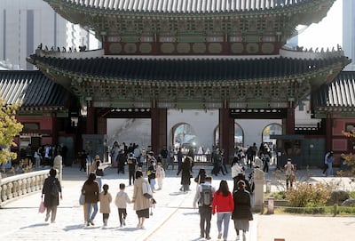 Tourists visit the ancient Gyeongbok Palace in Seoul, one of the city's top tourist attractions. EPA