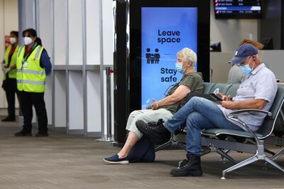 PERTH, AUSTRALIA - JANUARY 14: Passengers wait for for their flight wearing face masks at Perth Domestic Airport on January 14, 2021 in Perth, Australia. Face masks must now be worn at all airports in Western Australia, with those refusing to comply at risk of fines up to $50,000. The new rule also applies to people in vehicles picking up passengers. The face mask mandate has been introduced due to concerns about the UK strain of COVID-19. (Photo by Paul Kane/Getty Images)