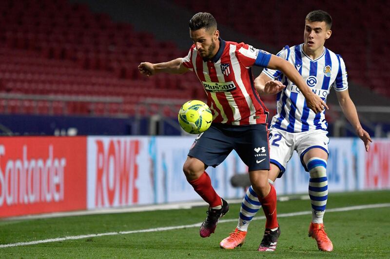 Atletico Madrid midfielder Koke vies with Real Sociedad's Ander Barrenetxea. AFP