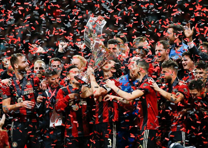 Atlanta United captain Michael Parkhurst kisses the trophy. AP Photo