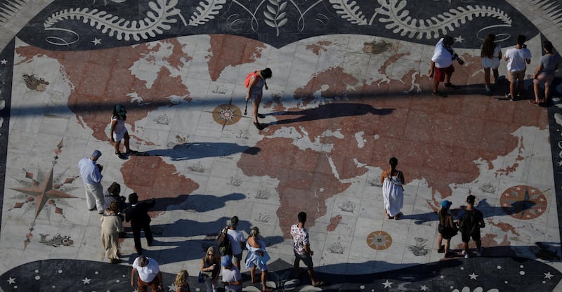 People take pictures at a square decorated with a giant world map in Lisbon, Portugal September 6, 2017. REUTERS/Rafael Marchante