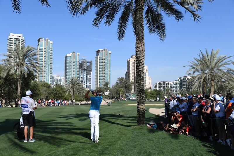 Ian Poulter hits his second shot on the 13th hole during the final round of the Omega Dubai Desert Classic. Ross Kinnaird / Getty Images