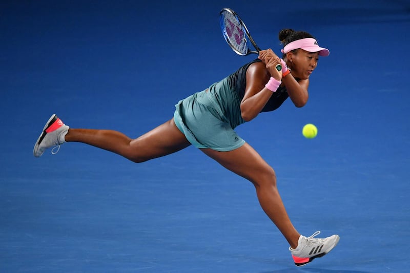 Japan's Naomi Osaka hits a return against Czech Republic's Petra Kvitova during the women's singles final on day 13 of the Australian Open tennis tournament in Melbourne on January 26, 2019. (Photo by Paul Crock / AFP) / -- IMAGE RESTRICTED TO EDITORIAL USE - STRICTLY NO COMMERCIAL USE --