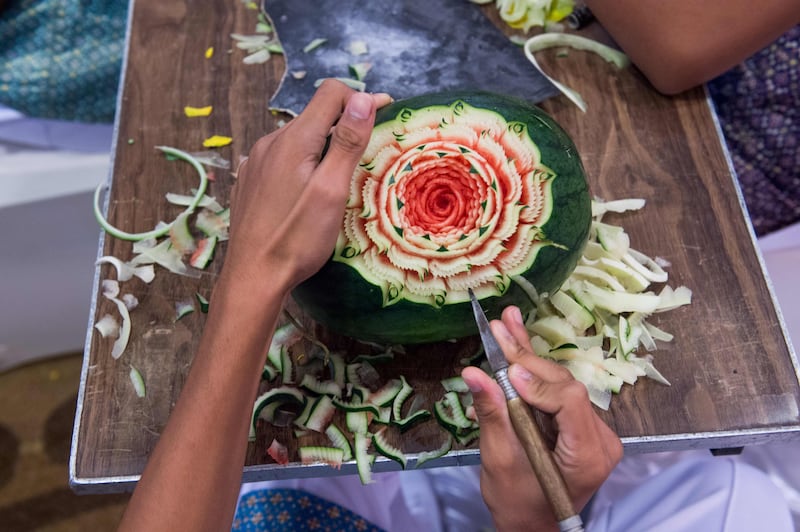 A Thai boy carves floral patterns into a watermelon during a fruit and vegetable carving competition in Bangkok. Robert Schmidt / AFP