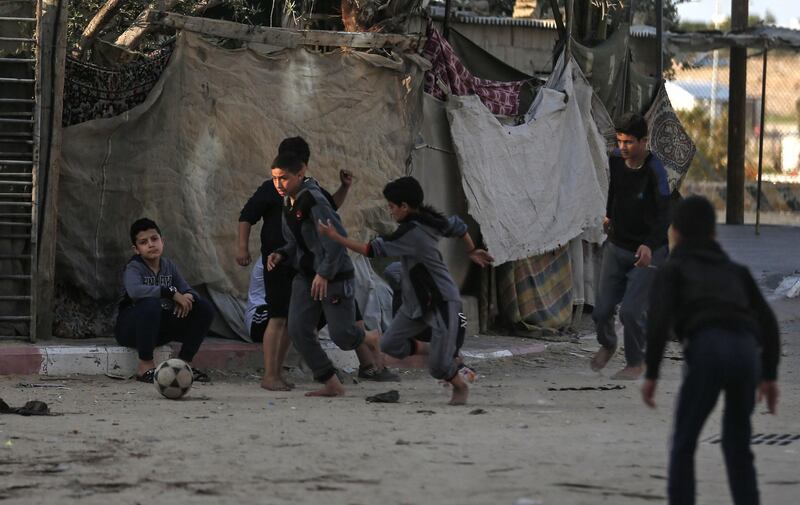 Palestinian children play football at a refugee camp in Khan Yunis in the southern Gaza Strip.  AFP
