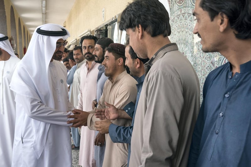 ABU DHABI, UNITED ARAB EMIRATES -  February 22, 2018: HH Sheikh Mohamed bin Zayed Al Nahyan, Crown Prince of Abu Dhabi and Deputy Supreme Commander of the UAE Armed Forces (L), greets staff at the carpet market in Mina Zayed Port area. 
( Ryan Carter for the Crown Prince Court - Abu Dhabi )
---
