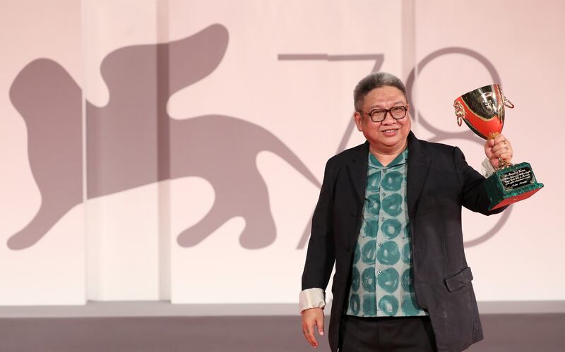 VENICE, ITALY - SEPTEMBER 11: Director Erik Matti poses, on behalf of actor John Arcilla, with the Coppa Volpi for Best Actor for "On the Job: The Missing 8" at the awards winner photocall during the 78th Venice International Film Festival on September 11, 2021 in Venice, Italy. (Photo by Marc Piasecki / Getty Images)