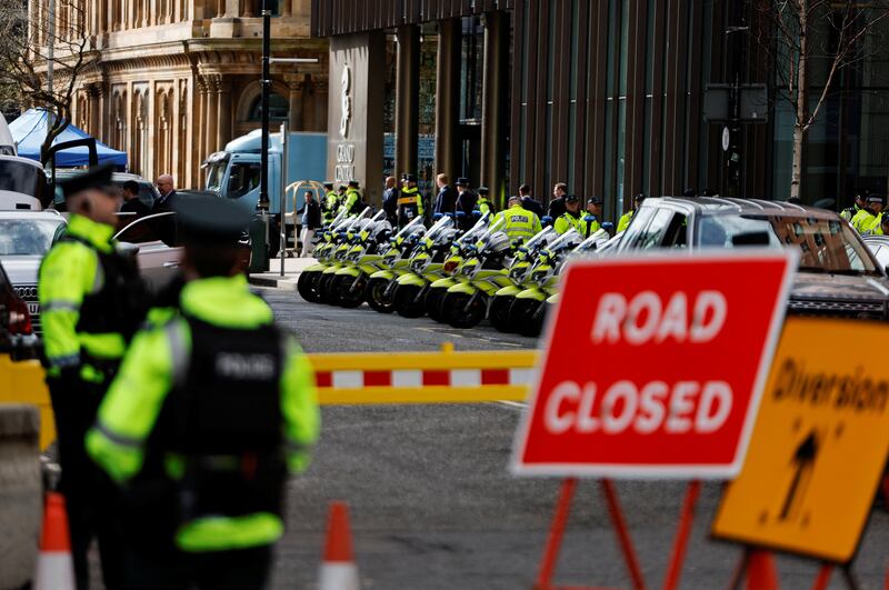 Police officers stand guard outside the Grand Central Hotel where Mr Biden is staying in Belfast. Reuters