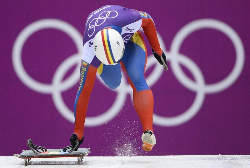 Romania's Dorin Velicu dons a helmet spanned by the stripes of the Romanian flag. Lionel Bonaventure / AFP