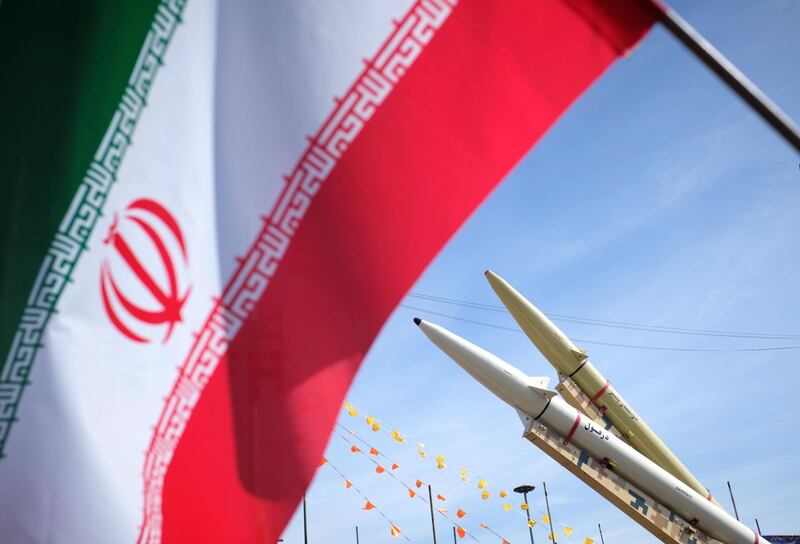 Iran-made, Dezful medium range ballistic missile (Bottom) and Zolfaghar road-mobile single-stage solid-propelled liquid fueled missile are seen next to an Iran flag in the Azadi (Freedom) square during a rally to commemorate the 42nd Victory anniversary of the Islamic Revolution, that held with motorcycles amid the new coronavirus disease (COVID-19) outbreak in Iran, in Tehran on February 10, 2021, on February 10, 2021.  (Photo by Morteza Nikoubazl/NurPhoto via Getty Images)