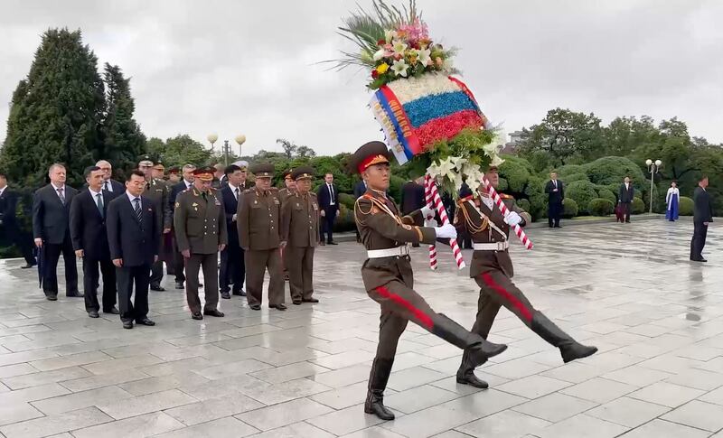 Mr Shoigu attends a wreath-laying ceremony at the Liberation Monument in Pyongyang. EPA